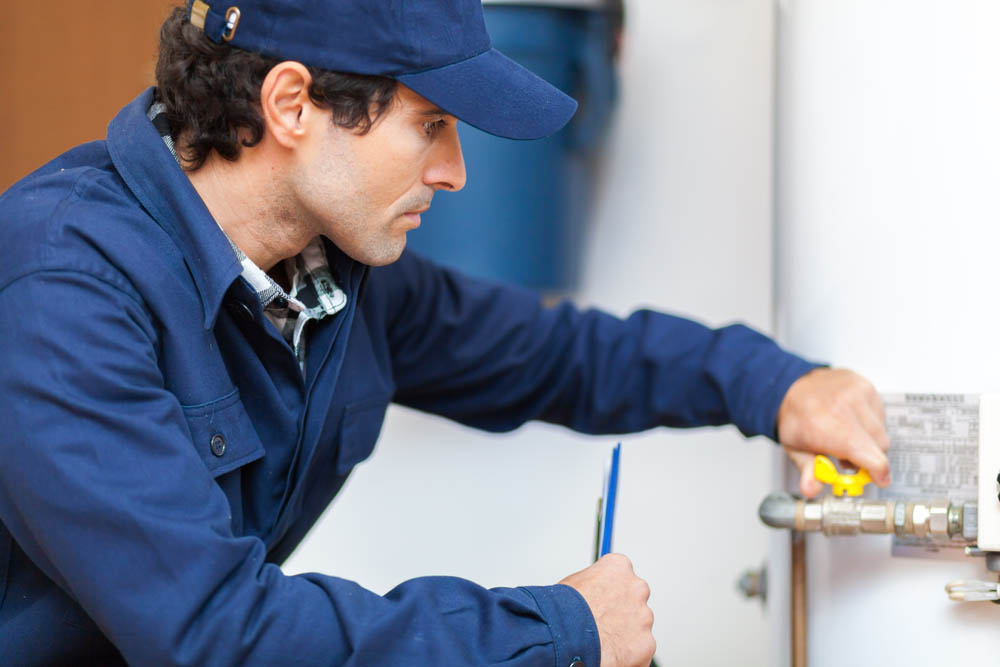 plumber inspecting water heater Glen Burnie, MD